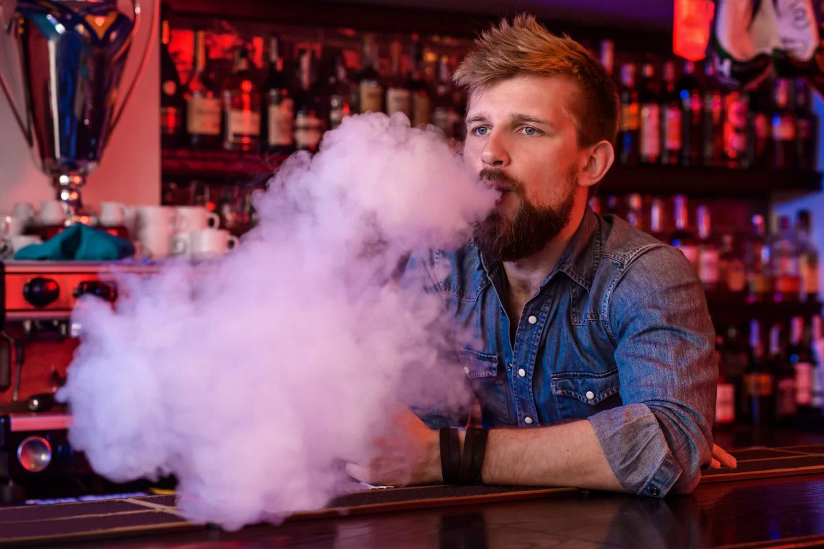 person vaping large clouds, powerful vape experience, vape power mode activated - 9 Best Vapes for Clouds: Top Picks for Beginners and Cloud Chasers ...